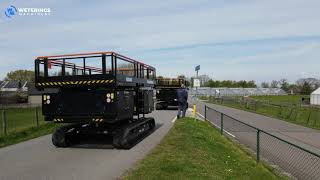 Placing two Top Spin R scissor lifts in a container and prepare for transport