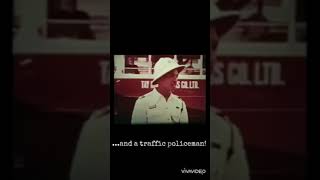 Short clip 1956 view of a Singapore street with a Tay Koh Yat bus and a traffic policeman too.