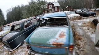 Old abandoned car cementary in the middle of the forest in Sweden