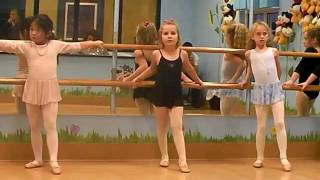 Lauren doing kicks at the barre