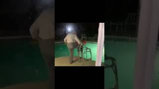 An old man teaches a kid to swim