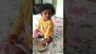 Alex 10 months old boy is playing with comb and a plate.