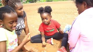 Betty bayo in the village with her kids playing village games