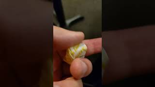 Halls honey lemon cough drop is a small paper wrapper.