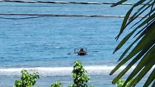 fishermen setting his fish pot at sea