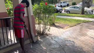 Boys cleaning and washing the driveway