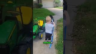 Little boy tows his toy car with his tractor 👏