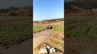 Crawler dumper is running in muddy water.