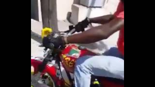 Sizzla Kalonji doing bike stunts