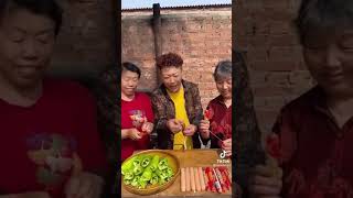 Grandma cooking stuffed green peppers with sausage