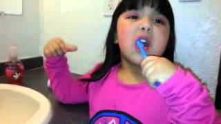 4 year old with a perfect smile brushing teeth