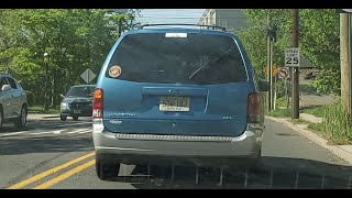 Two Tone Ford Windstar SEL Driving on Road