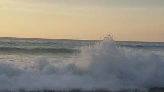 Splashing at Sunset Dreamland Beach, Bali, Indonesia