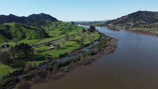 A Road between Green Hills and a River