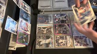 Baseball cards going through binder