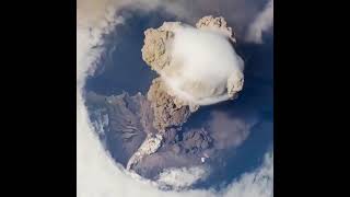 An erupting volcano seen from space