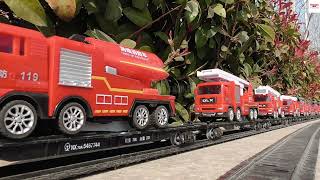 Massive Load Of Fire Trucks Carring By HO Scale Model Train With Double Head Engines