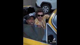 Harry chilling with a friend in a car