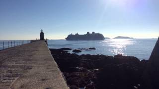 P&O Britannia offloads her tenders opposite St Peter Port breakwater.