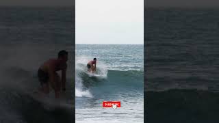 Handheld Long Shot of Surfer Riding a Wave