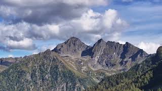 The mountains are covered in snow and clouds