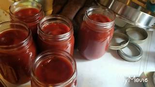 Making and canning homemade pasta sauce from home grown tomatoes and canned tomato sauce.