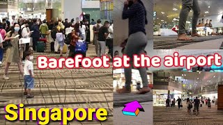 Barefoot at the airport of Singapore. The largest, cleanest, busiest and most entertaining airport.