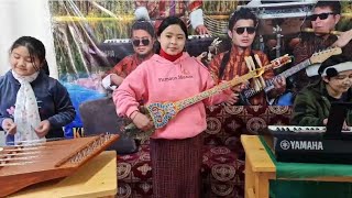 Bhutanese youths practicing traditional musical instruments at Kuenpel Entertainment