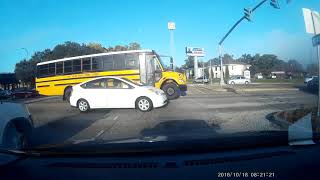 At 1:58 an SUV runs a red light and almost crashes horribly into a school bus.