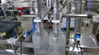 Automatic Liqud filling machine with 2 filling nozzles, nozzles rising when filling