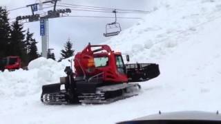 Snow cat building a massive pile of snow up