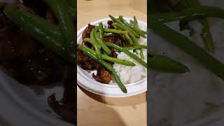 Teriyaki beef and string beans serve with white rice.