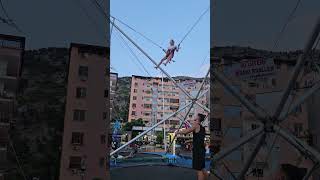 Banjo.Tina flies on a trampoline. Albania. Shëngjin.