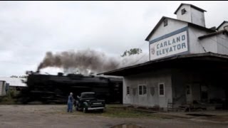 Antique Chevy pickup truck greets steam locomotive #765 hauling freight through Carland, MI