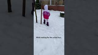 kindergarten school kid waiting for school bus during winter