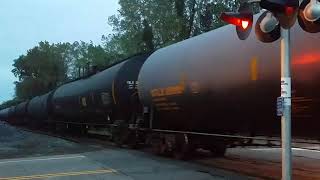 Conrail (CSX) tanker train with Union Pacific engine Passing the crossing on the National Docks