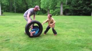 Carson and Zachary rolling in a truck tire