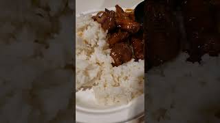 Manchurian pork and onions serve with white rice.