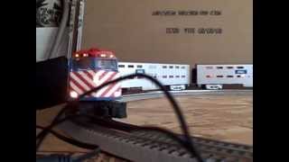 Metra MTH F40PH 113 leads slow outbound express train in O guage.