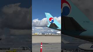 AtlasAir 747 taking off while KoreanAir pushes back.