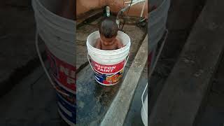 Baby playing in water at home