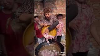 Chinese Grandma cooking braised pork belly with quail eggs