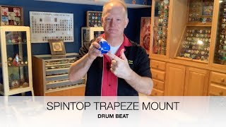 Spintop trapeze mount and drum beat regeneration trick