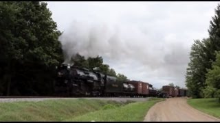 NKP Berkshire #765 rolls a freight train past  an antique Chevy pickup truck