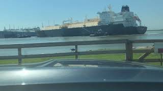 Tugboats Maneuver Ship out of Dock