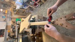 Hand carving guitar neck on an Explorer style guitar