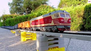 Super Long HO Scale Model Train Carring Containers On An Elevated Railroad