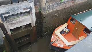 Ashton Canal Lock - houseboat passing through lock