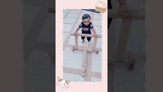 cute child walking with wooden walker