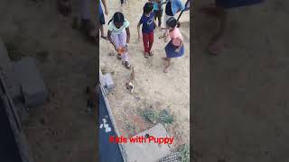 Kids offering water to thirsty puppy